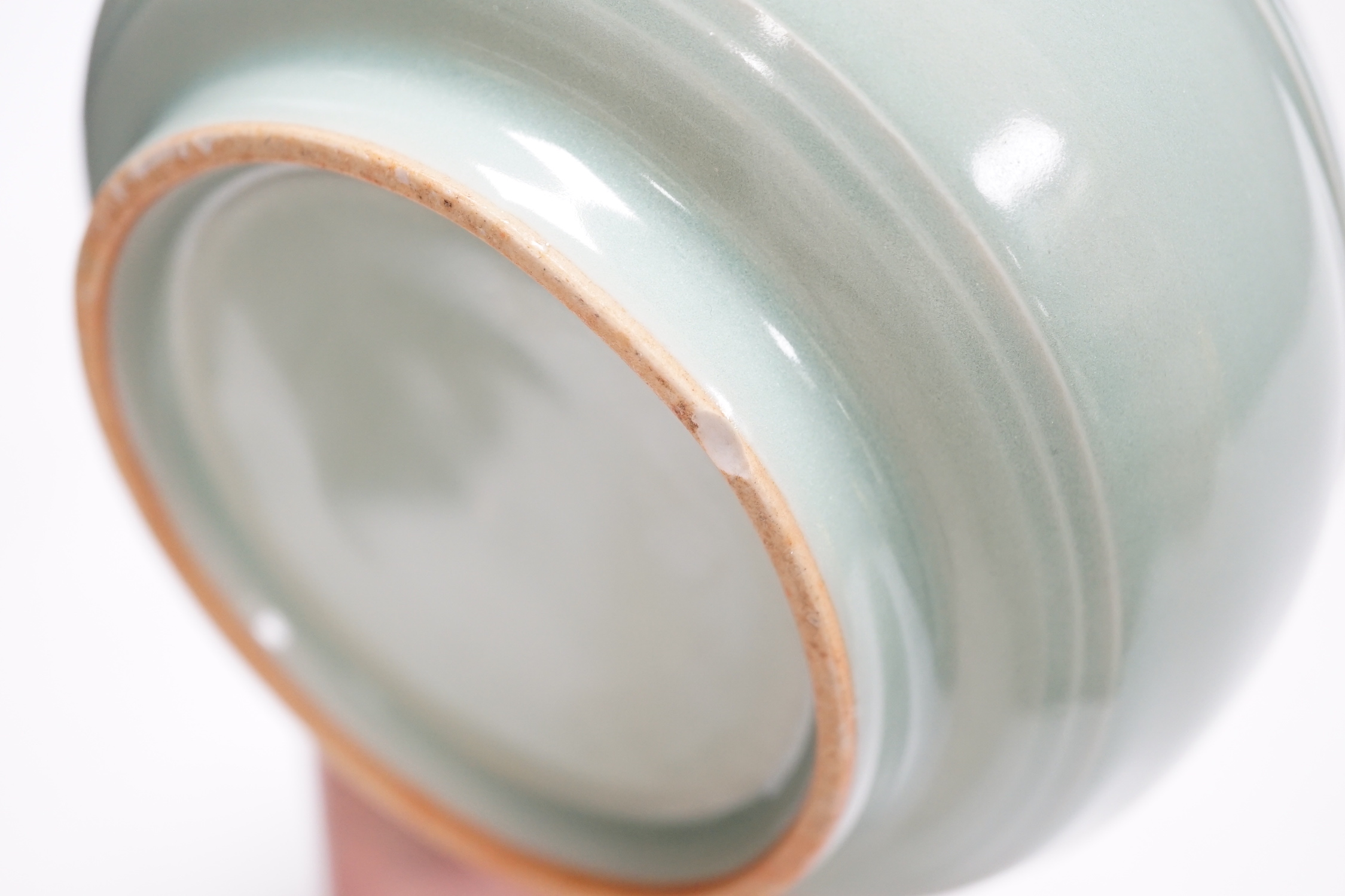 A Chinese celadon glazed pot, 8cm high